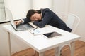 Young Asian business woman lying down on the desk in office because tired overworked. Royalty Free Stock Photo