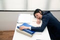 Young Asian business woman lying down on the desk in office because tired overworked. Royalty Free Stock Photo