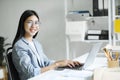 Young asian business woman or student working online on computer laptop. Royalty Free Stock Photo