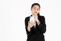 Young Asian business woman in suit holding mobile smart phone over white isolated background Royalty Free Stock Photo