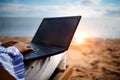 Asian business woman with tablet computer during tropical beach vacation. Freelancer working on laptop lying on sun lounger. Royalty Free Stock Photo