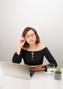 Young asian business woman thinking daydreaming sitting at desk with laptop computer Royalty Free Stock Photo