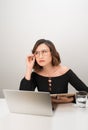 Young asian business woman thinking daydreaming sitting at desk with laptop computer Royalty Free Stock Photo