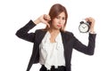 Young Asian business woman thumbs down with a clock Royalty Free Stock Photo