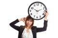 Young Asian business woman thumbs down with a clock Royalty Free Stock Photo