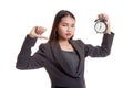 Young Asian business woman thumbs down with a clock. Royalty Free Stock Photo