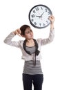 Young Asian business woman thumbs down with a clock. Royalty Free Stock Photo