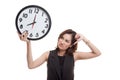 Young Asian business woman thumbs down with a clock. Royalty Free Stock Photo