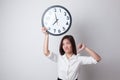 Young Asian business woman thumbs down with a clock. Royalty Free Stock Photo