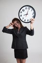 Young Asian business woman thumbs down with a clock. Royalty Free Stock Photo