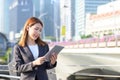Young Asian business woman using laptop working in urban city Royalty Free Stock Photo