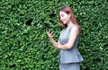 Young Asian business woman using mobile phone at park. Lifestyle and technology concept Royalty Free Stock Photo