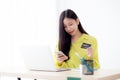 Young asian business woman using smart phone and holding credit card while online shopping and payment online.. Royalty Free Stock Photo