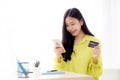 Young asian business woman using smart phone and holding credit card while online shopping and payment online.. Royalty Free Stock Photo