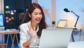 Young Asian business woman on video conference call, using laptop computer work late night. Remote meeting, work at home Royalty Free Stock Photo