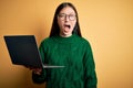Young asian business woman wearing glasses and working using computer laptop angry and mad screaming frustrated and furious, Royalty Free Stock Photo
