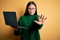 Young asian business woman wearing glasses and working using computer laptop doing stop gesture with hands palms, angry and Royalty Free Stock Photo