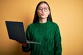 Young asian business woman wearing glasses and working using computer laptop looking at the camera blowing a kiss on air being Royalty Free Stock Photo