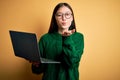 Young asian business woman wearing glasses and working using computer laptop looking at the camera blowing a kiss with hand on air Royalty Free Stock Photo