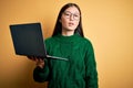 Young asian business woman wearing glasses and working using computer laptop looking sleepy and tired, exhausted for fatigue and Royalty Free Stock Photo