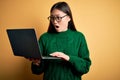 Young asian business woman wearing glasses and working using computer laptop Looking at the watch time worried, afraid of getting Royalty Free Stock Photo