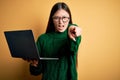 Young asian business woman wearing glasses and working using computer laptop pointing displeased and frustrated to the camera, Royalty Free Stock Photo