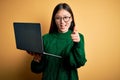 Young asian business woman wearing glasses and working using computer laptop pointing fingers to camera with happy and funny face Royalty Free Stock Photo