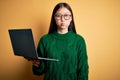 Young asian business woman wearing glasses and working using computer laptop puffing cheeks with funny face Royalty Free Stock Photo