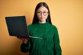 Young asian business woman wearing glasses and working using computer laptop Relaxed with serious expression on face