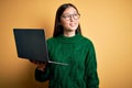 Young asian business woman wearing glasses and working using computer laptop smiling looking to the side and staring away thinking Royalty Free Stock Photo