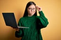 Young asian business woman wearing glasses and working using computer laptop worried and stressed about a problem with hand on Royalty Free Stock Photo