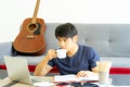 Young Asian businessman work from home using teleconference from notebook laptop. Royalty Free Stock Photo