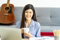 Young Asian business woman work from home using teleconference from notebook laptop.  social distancing new normal concept Royalty Free Stock Photo
