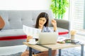 Young Asian business woman work from home using teleconference from notebook laptop. Royalty Free Stock Photo