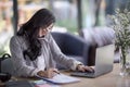 young asian business woman working behind a desk with laptop talk Royalty Free Stock Photo