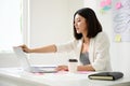 Young asian business woman working on computer laptop in office room with paperwork document Royalty Free Stock Photo