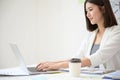 Young asian business woman working on computer laptop in office room with paperwork document Royalty Free Stock Photo