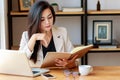 Young Asian business woman working at workplace. beautiful Asian woman in casual suit working with reading book Royalty Free Stock Photo