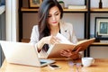 Young Asian business woman working at workplace. beautiful Asian woman in casual suit working with reading book, Royalty Free Stock Photo
