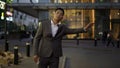 Young asian businessman, catching a taxi toward business meeting at downtown district. Evening time. Royalty Free Stock Photo