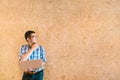 Young Asian businessman or college student with laptop, thinking and looking at copy space Royalty Free Stock Photo