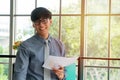 Young Asian businessman excited happy and celebrating success in the workplace after see finalizing the annual sales report. Conce Royalty Free Stock Photo