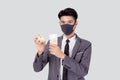 Young asian businessman in face mask holding money Thai and home isolated on white background.