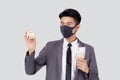 Young asian businessman in face mask holding money Thai and home isolated on white background.