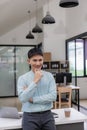 Young Asian businessman in his office and smiling with crossed arms. Young Asian businessman, successful professional, millennial, Royalty Free Stock Photo