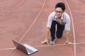 Young Asian businessman with laptop ready start position to forward on race track. Competition and vision business concept