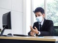 Young Asian businessman pain while using notebook computer in office Royalty Free Stock Photo