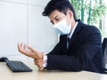 Young Asian businessman pain while using notebook computer in office Royalty Free Stock Photo