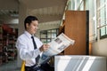 Young Asian businessman reading a newspaper Royalty Free Stock Photo