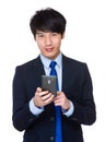 Young asian businessman sends a text message
